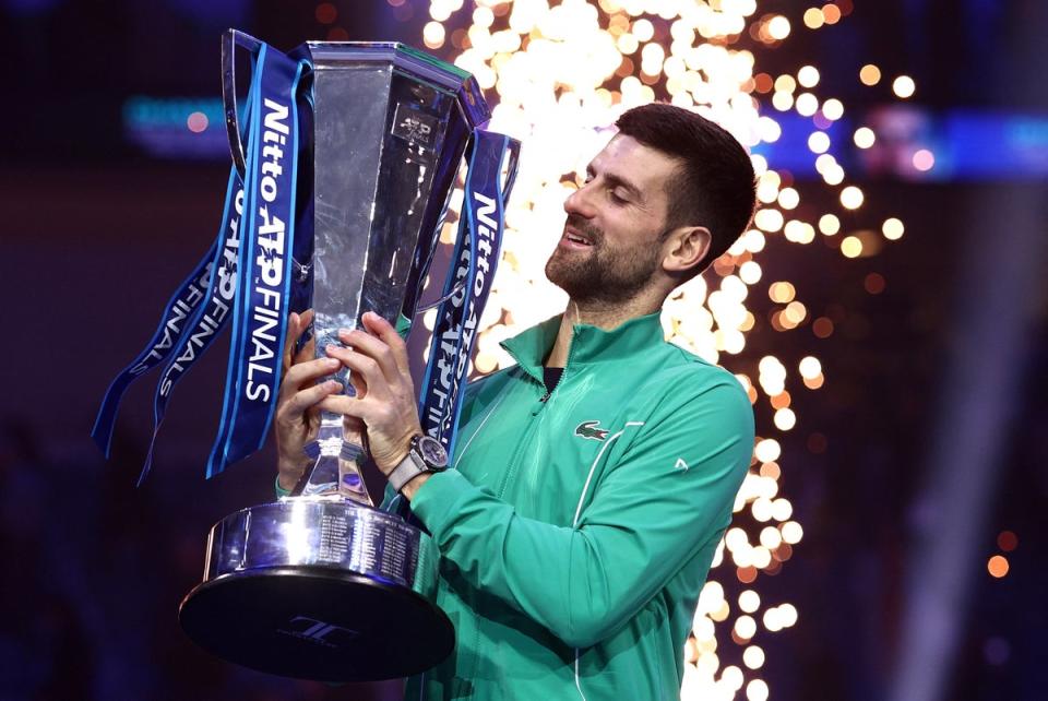 Djokovic celebrates with a trophy after winning the ATP Finals (Reuters)