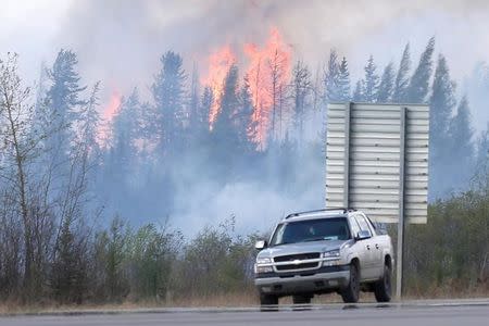 A wildfire burns near Highway 63 south of Fort McMurray, Alberta, Canada, May 8, 2016. REUTERS/Chris Wattie