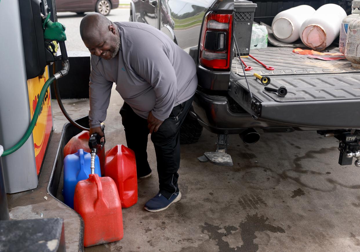 A resident, Jessie Walker, fills containers with fuel as he prepares for the arrival of Hurricane Debby in Lee, Florida (Getty Images)