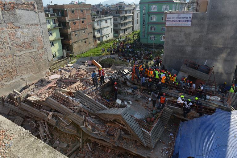 Rescue teams search for survivors at a collapsed building in Kathmandu, on May 12, 2015