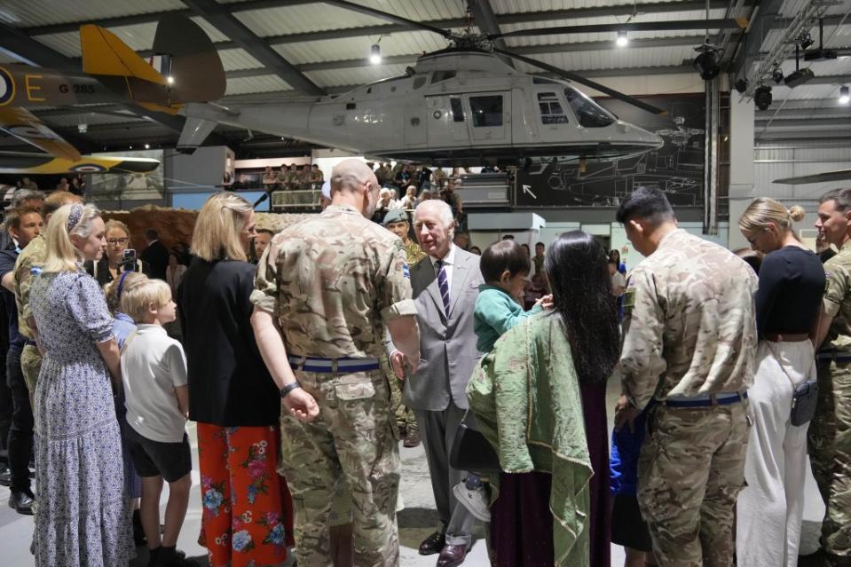 King Charles III talks to members of the British army and their families on May 13, 2024. Kin Cheung/WPA Pool/Shutterstock