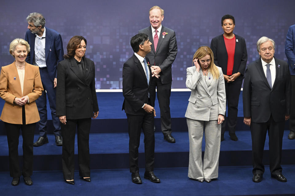 First row, from left, European Commission President Ursula von der Leyen, U.S. Vice President Kamala Harris, British Prime Minister Rishi Sunak, Italy's Prime Minister Giorgia Meloni, UN Secretary General Antonio Guterres, back row from left, Yoshua Bengio, founder and scientific director of Mila at the Quebec AI Institute, Vice Chair and President at Microsoft Brad Smith, White House Office of Science and Technology Policy acting director Alondra Nelson pose for a group photo, on the second day of the UK Artificial Intelligence (AI) Safety Summit, at Bletchley Park, in Bletchley, England, Thursday, Nov. 2, 2023. (Leon Neal/Pool Photo via AP)