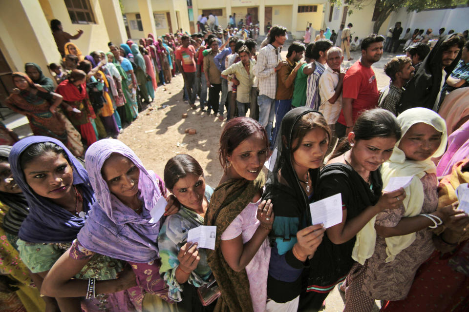 Indians stand in a queue to cast their votes outside a polling station during parliamentary elections in Jammu, India, Thursday, April 10, 2014. Millions of people are voting in the third phase of the elections Thursday, covering parts of 11 of India's 28 states. The multiphase voting across the country runs until May 12, with results for the 543-seat lower house of parliament announced May 16. (AP Photo/Channi Anand)