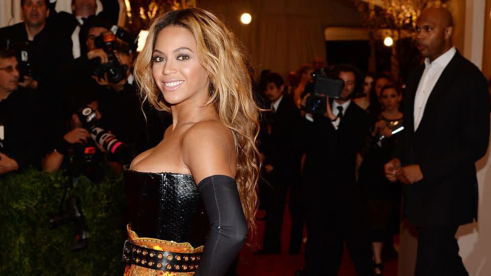 Beyoncé Knowles sporting a thigh-high slit gown at the Met Gala the next year. - Dimitrios Kambouris/Getty Images