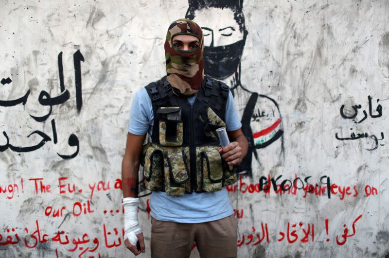 FILE PHOTO: Hussein Karim Hashem, an Iraqi demonstrator, poses for a photograph during the ongoing anti-government protests in Baghdad