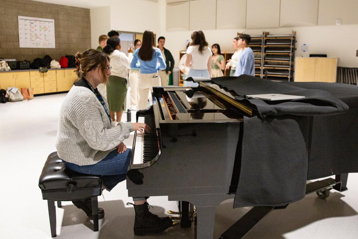 Choir director and band teacher Hannah Abercrombie plays the piano for Scots-Appella as they warm up their voices.