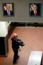 <p>A farmworker passes under portraits of the president and vice-president in the pre-dawn hours from Mexicali, Mexico, through the Calexico Port of Entry in Calexico, Calif., March 6, 2018. (Photo: Gregory Bull/AP) </p>