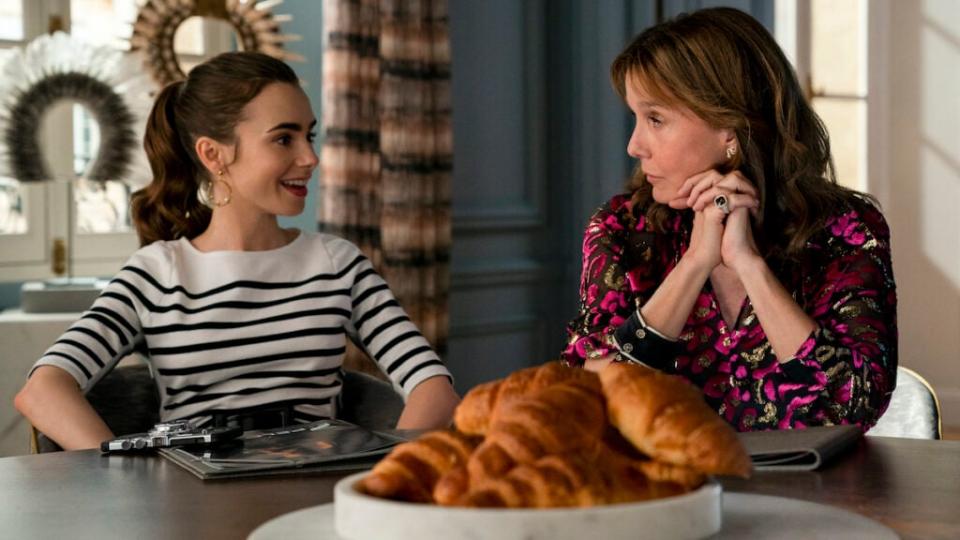 Emily in Paris. (L to R) Lily Collins as Emily, Philippine Leroy-Beaulieu as Sylvie in episode 207 of Emily in Paris. Cr. Stéphanie Branchu/Netflix © 2021