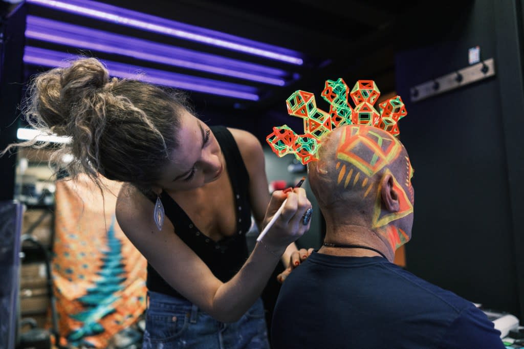 Chris said that the headpiece is just one part of the character he creates. In this photo, Renee Orshan applies makeup to his head. Stephen Yang
