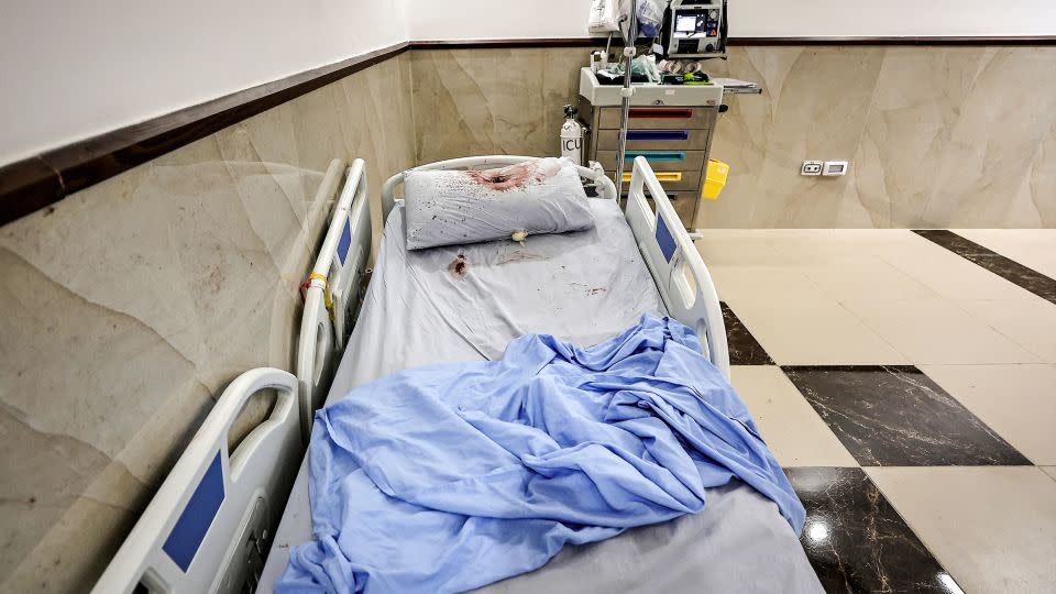 A bullet hole is pictured on a blood-spattered pillow at the Ibn Sina hospital in Jenin, West Bank, on January 30.  - Zain Jaafar/AFP/Getty Images