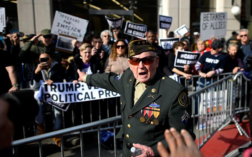 Protestors hold signs during a rally against US President Donald Trump, near the Veterans Day Parade on Nov. 11, at 2019 in New York City. (Photo: Johannes Eisele/AFP via Getty Images)