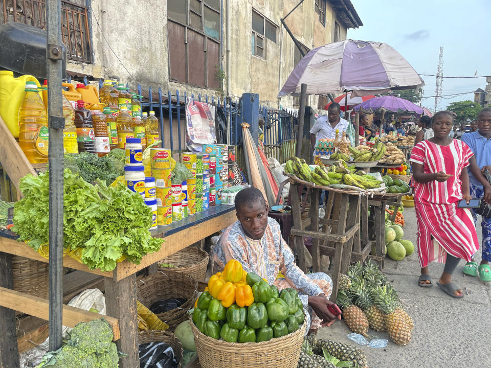 People shop at a market in Lagos, Nigeria Wednesday, Nov 29, 2023. Nigeria's leader on Wednesday presented a $34 billion spending plan for 2024 to federal lawmakers with a key focus on stabilizing Africa's largest but ailing economy and fighting the nation's deadly security crisis. (AP Photo/Sunday Alamba)