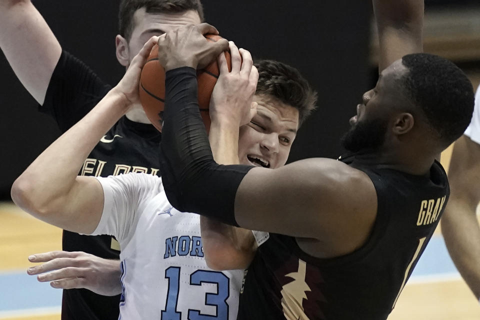 Florida State forward RaiQuan Gray (1) and North Carolina forward Walker Kessler (13) struggle for the ball during the first half of an NCAA college basketball game in Chapel Hill, N.C., Saturday, Feb. 27, 2021. (AP Photo/Gerry Broome)