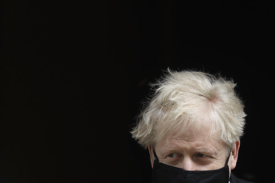 Britain's Prime Minister Boris Johnson leaves 10 Downing Street to attend the weekly session of Prime Ministers Questions in Parliament in London, Wednesday, April 14, 2021. (AP Photo/Kirsty Wigglesworth)