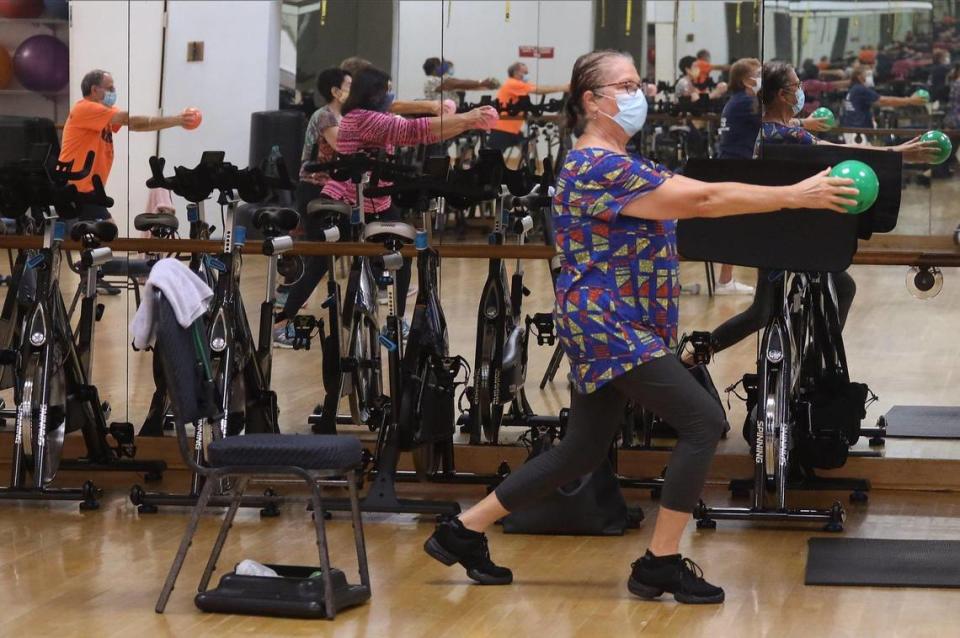 Adele Barndollar, right, works out recently during the SilverSneakers fitness classes at the Alper Jewish Community Center in Kendall.