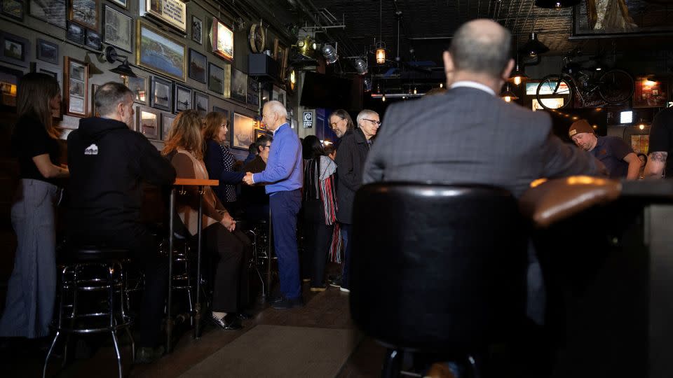 Biden greets patrons inside the Cedar Lounge Tap Room in Superior on Thursday. - Tom Brenner/Reuters