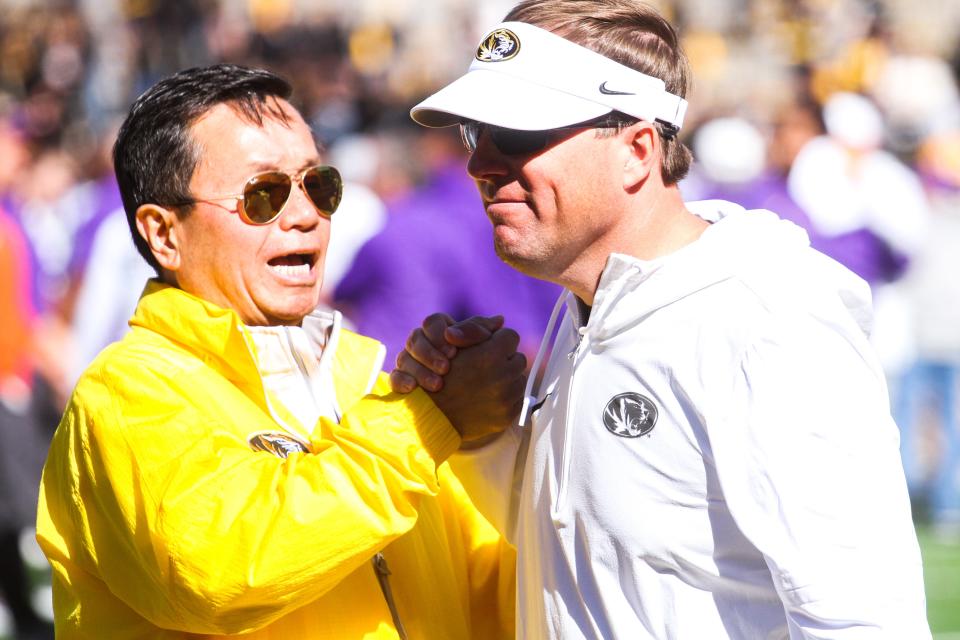 UM System President Mun Choi, left, greets Missouri head coach Eli Drinkwitz, right, after Missouri's 49-39 loss against LSU at Faurot Field on Oct. 7, 2023, in Columbia, Mo.