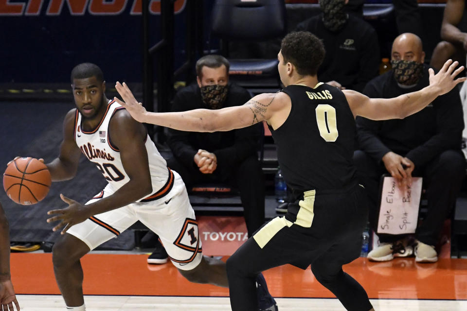 Illinois guard Da'Monte Williams (20) drives the ball as Purdue's forward Mason Gillis (0) defends in the first half of an NCAA college basketball game Saturday, Jan. 2, 2021, in Champaign, Ill. (AP Photo/Holly Hart)