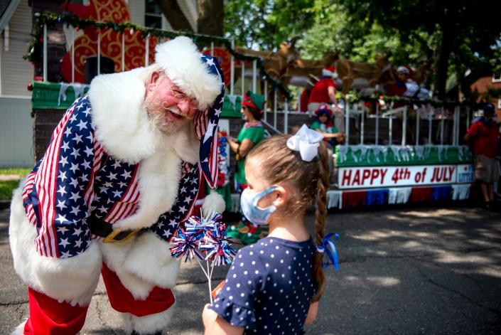 Ridgefield Park holds it&#39;s 127th Fourth of July parade on Monday, July 5, 2021. Santa, played by Frank Vopasek of Little Ferry, listens to early Christmas presents wishes by Violett Raguseo of Little Ferry.