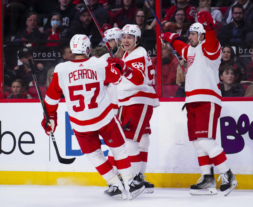 Detroit Red Wings left wing Tyler Bertuzzi (59) celebrates after his goal against the Ottawa Senators with teammates during first-period NHL hockey game action in Ottawa, Ontario, Monday, Feb. 27, 2023. (Sean Kilpatrick/The Canadian Press via AP)
