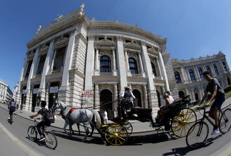A traditional Fiaker horse carriage passes Burgtheater theatre in Vienna, Austria, August 13, 2018. REUTERS/Heinz-Peter Bader