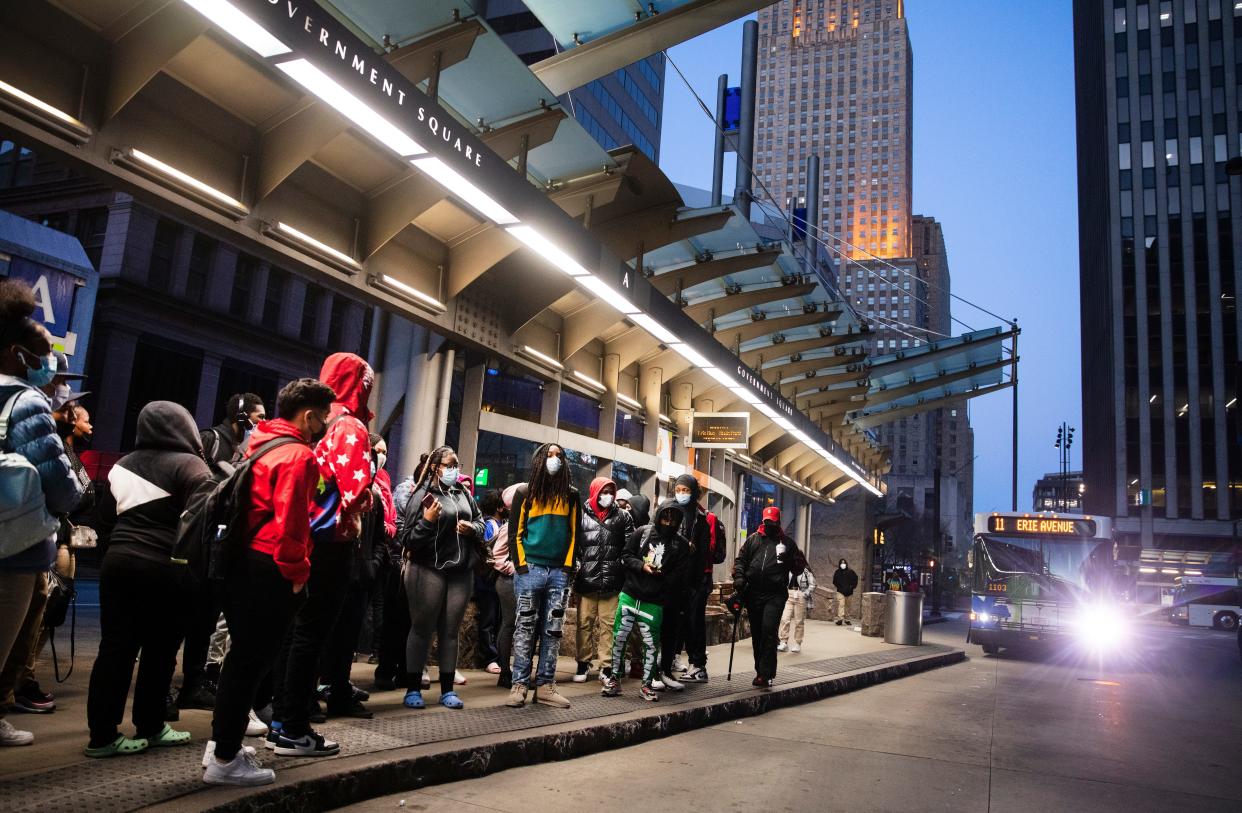 Early morning riders, mostly students, board the bus at Government Square, Monday, March 21, 2022.