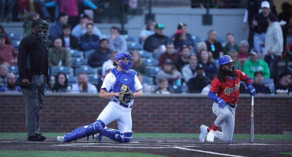 The Rockers’ D.J. Burt, right, gets back up after nearly being hit by a hit during the Legends’ season opener Thursday.