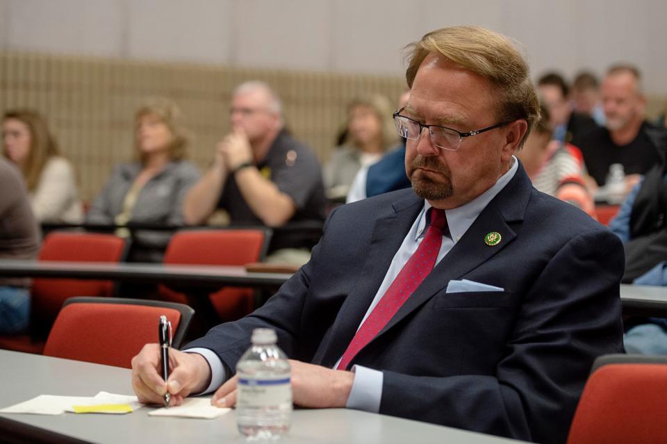 Congressman Chuck Edwards takes notes during a gathering of community leaders in light of the Canton paper mill closure at Haywood Community College March 10, 2023.