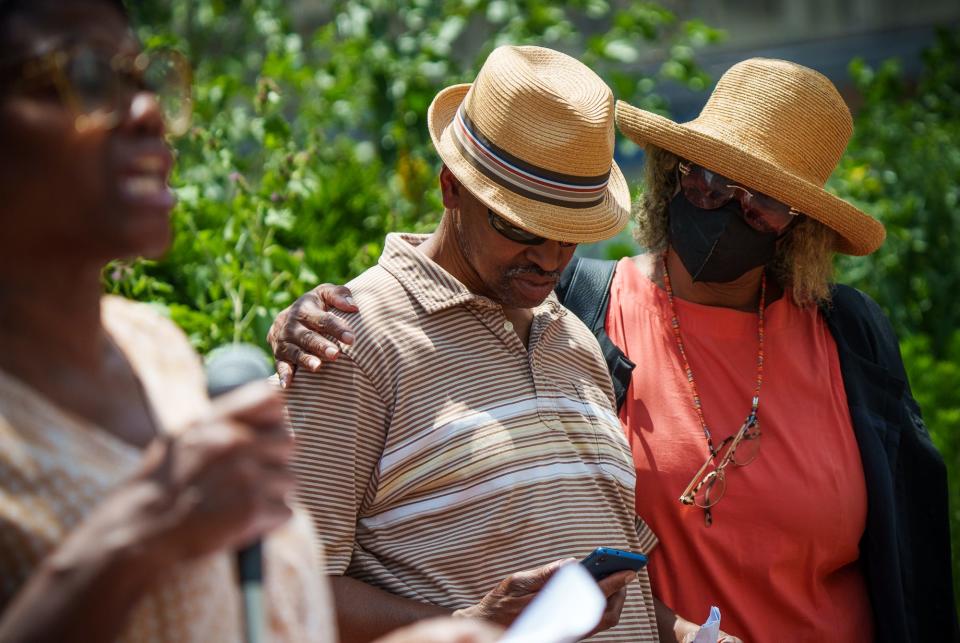 Gladys Whitfield comforts husband Herman Whitfield Jr. on Friday, July 1, 2022, after he spoke to local media about the death of their son, Herman Whitfield III, during a press conference at Plaza at City Market.