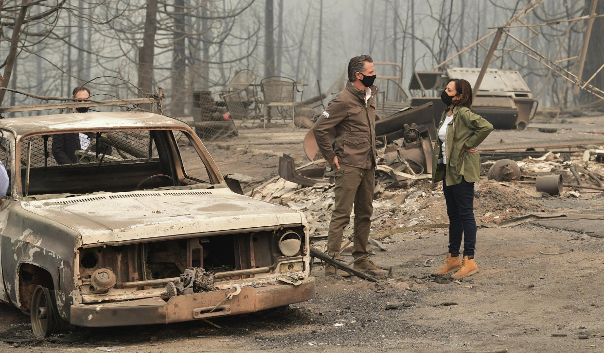  Kamala Harris, right, wearing Timberland boots, and California Gov. Gavin Newsom visit the scene of fire-ravaged property near Fresno, Calif., on Sept. 15, 2020.