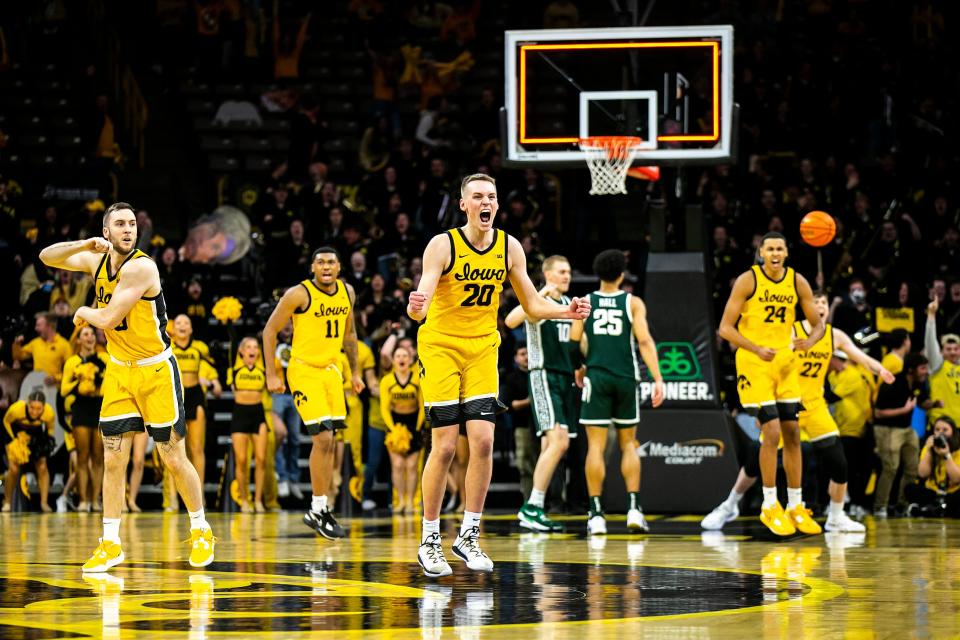 Iowa forward Payton Sandfort (20) reacts after making a 3-point basket against Michigan State, Saturday, Feb. 25, 2023, at Carver-Hawkeye Arena in Iowa City, Iowa.