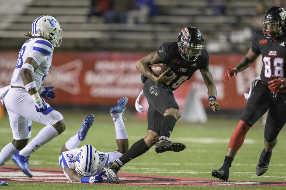 Louisiana-Lafayette wide receiver Jalen Williams (18) breaks a tackle attempt by Georgia State safety Antavious Lane (34) during the first half an NCAA college football game in Lafayette, La., Thursday, Nov. 4, 2021. (AP Photo/Matthew Hinton)