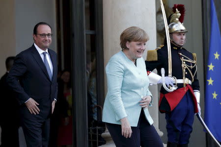 French President Francois Hollande looks at German Chancellor Angela Merkel as she leaves the Elysee Palace in Paris, France, July 6, 2015 following the Greek people's resounding 'No' to a European cash-for-reform deal in a referendum in Greece. REUTERS/Philippe Wojazer