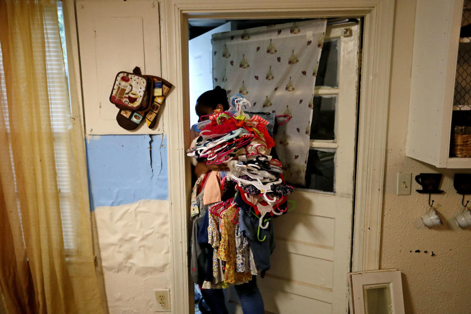 Rosemary Acevedo-Gonzalez retrieves her daughter's clothing as she returns to their home for the first time since it was flooded in the aftermath of Hurricane Florence in Spring Lake, N.C., Wednesday, Sept. 19, 2018. "This is the only thing I can get," said Acevedo-Gonzalez of what was salvageable. "That's it. I'm done." (AP Photo/David Goldman)