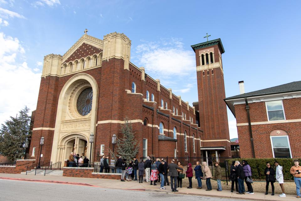 People wait in line on Sunday to enter Our Lady's Cathedral for a prayer vigil and an opportunity to pray near the casket bearing the body of Blessed Stanley Rother.