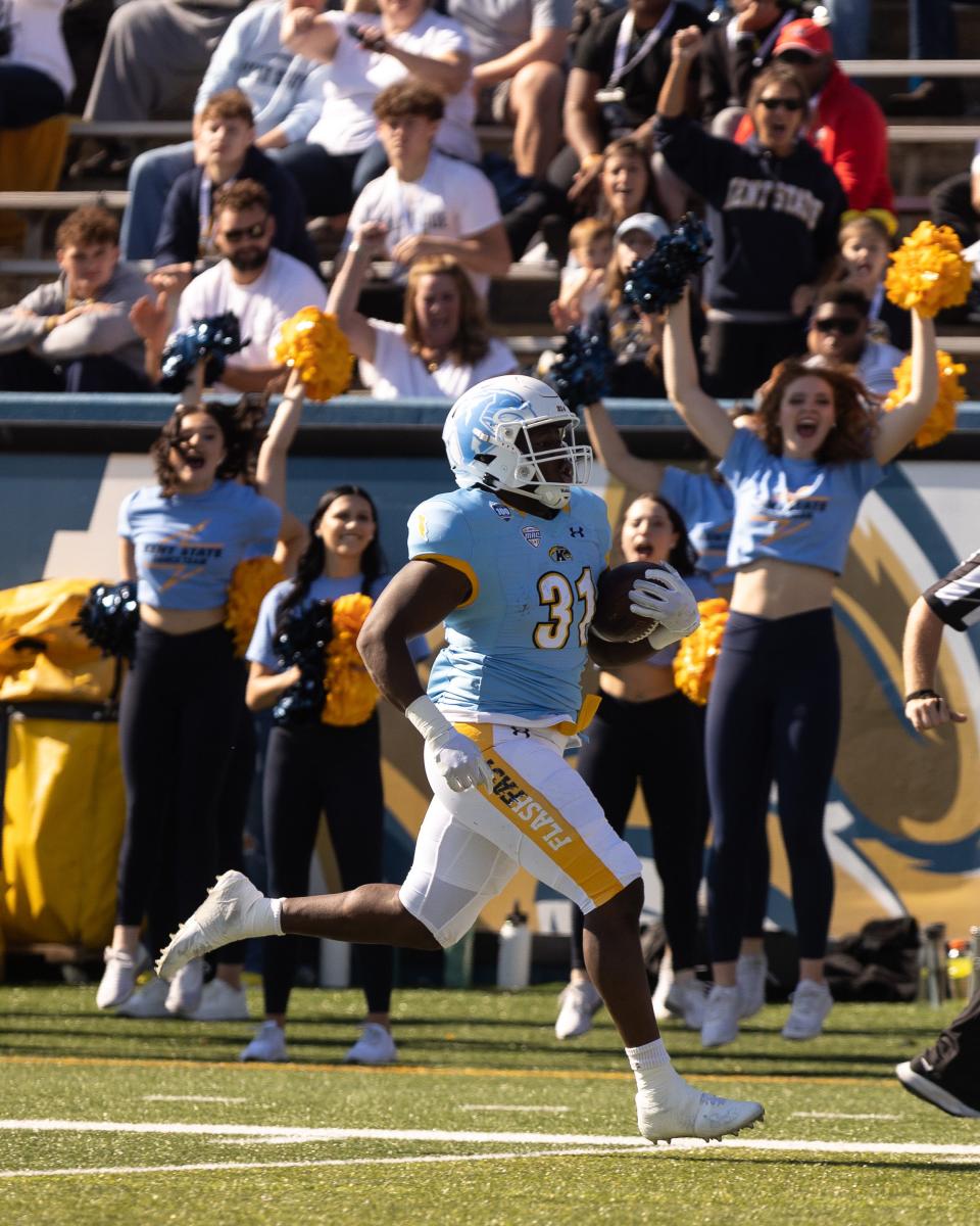 Kent State running back Bryan Bradford runs along the sideline to score a touchdown in the first half of Saturday's game against the Akron Zips at Dix Stadium.