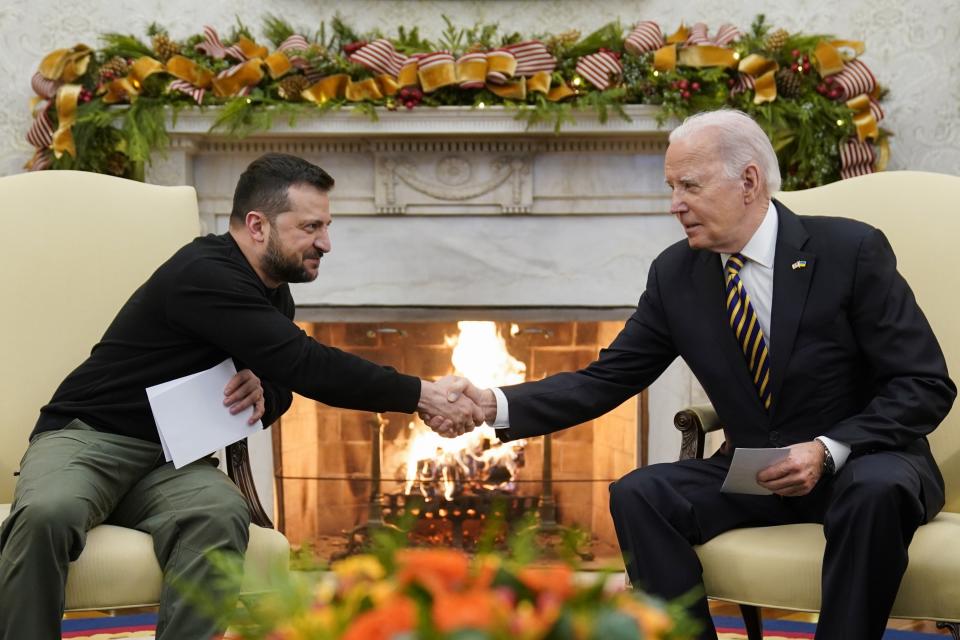 FILE - U.S. President Joe Biden shakes hands with Ukrainian President Volodymyr Zelenskyy as they meet at the White House, Tuesday, Dec. 12, 2023, in Washington. An aid package for Ukraine has stalled in the U.S. Congress as Republicans insist on linking any more money to U.S.-Mexico border security changes. (AP Photo/Evan Vucci, File)