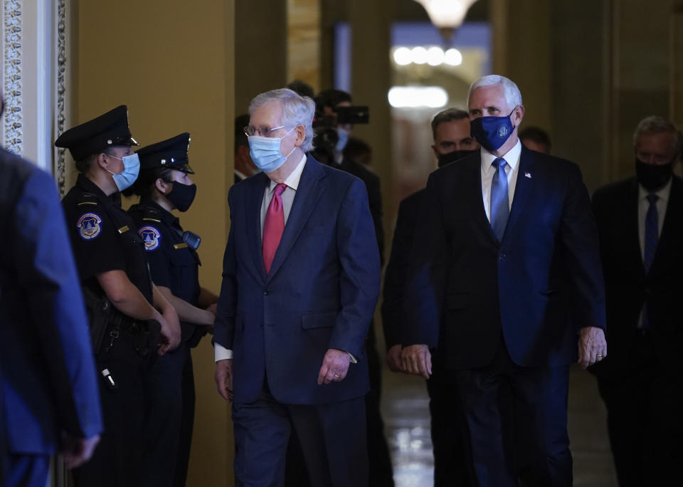 Senate Majority Leader Mitch McConnell, R-Ky., left, and Vice President Mike Pence, right, walk to hold a private meeting with Judge Amy Coney Barrett, President Donald Trump's nominee for the U.S. Supreme Court, at the Capitol in Washington, Tuesday, Sept. 29, 2020. (AP Photo/J. Scott Applewhite)