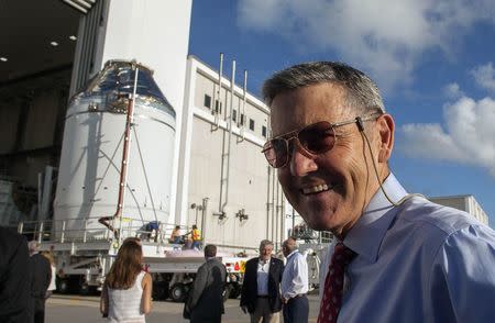 Kennedy Space Center director Bob Cabana watches as the Orion capsule sits on top of the service module as it is being moved from the Operations & Checkout Building (above) to the Payload Hazardous Servicing Facility at Kennedy Space Center, Florida September 11, 2014. REUTERS/Mike Brown