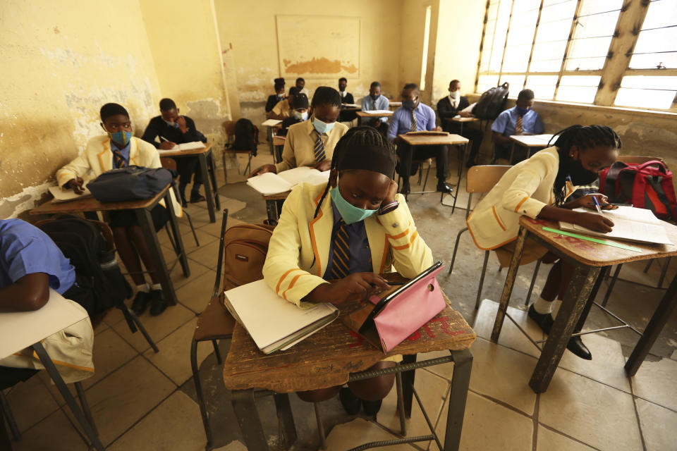 Pupils attend a class at a school in Harare, Monday, Sept, 28, 2020. Zimbabwe schools have reopened in phases, but with smaller number of pupils,more teachers and other related measures to enable children to resume their education without the risk of a spike in COVID-19 infections. (AP Photo/Tsvangirayi Mukwazhi)