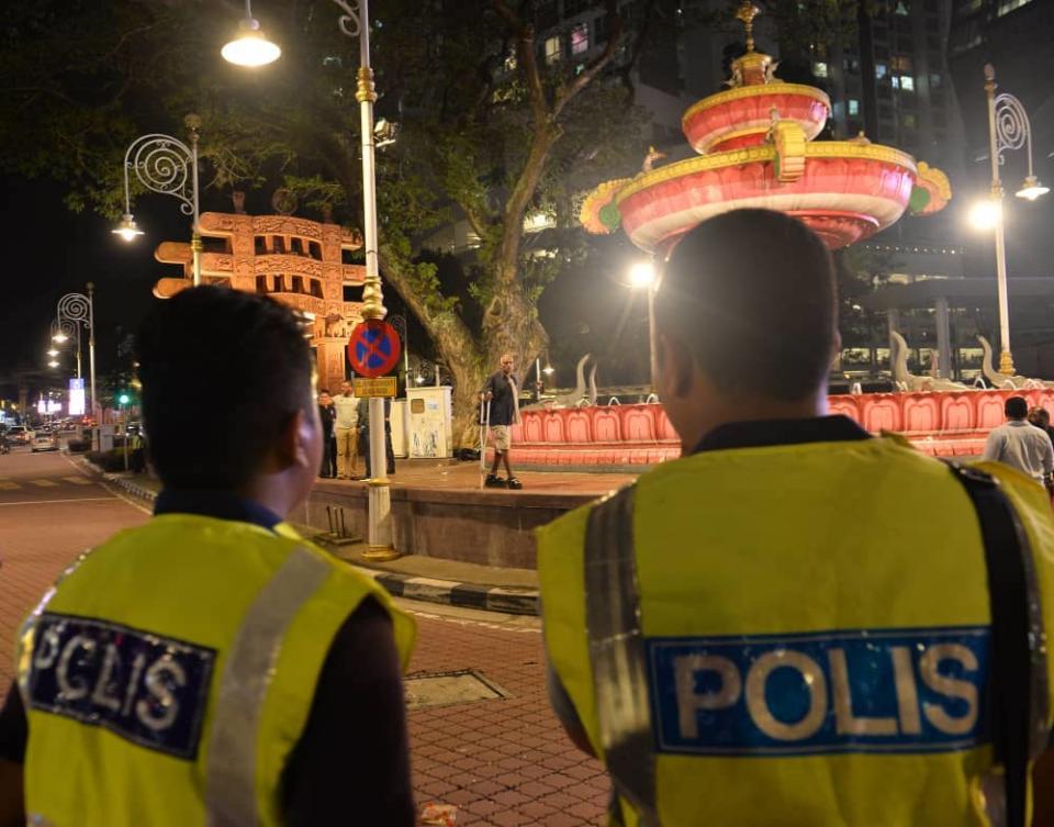 Police monitor a rally in Brickfields, Kuala Lumpur August 23, 2019.