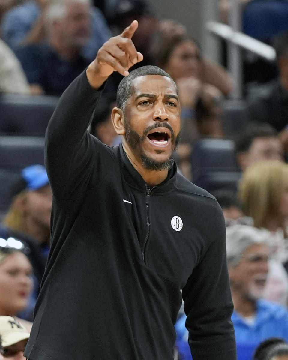 Brooklyn Nets interim coach Kevin Ollie directs players against the Orlando Magic during the first half of an NBA basketball game Wednesday, March 13, 2024, in Orlando, Fla. (AP Photo/John Raoux)