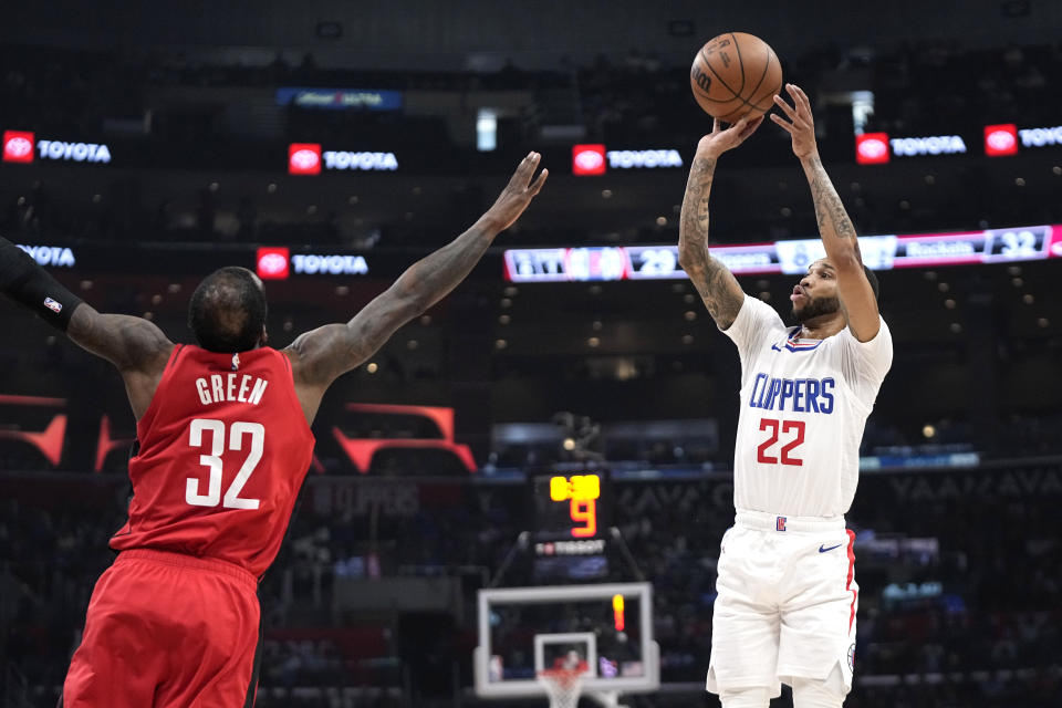 Los Angeles Clippers guard Xavier Moon, right, shoots as Houston Rockets forward Jeff Green defends during the first half of an NBA basketball game Sunday, April 14, 2024, in Los Angeles. (AP Photo/Mark J. Terrill)