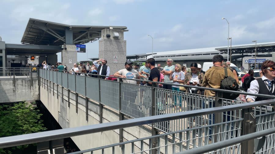 Folks line up at Austin-Bergstrom International Airport to watch the total solar eclipse on April 8, 2024. (KXAN Photo/Lauren Ryan)