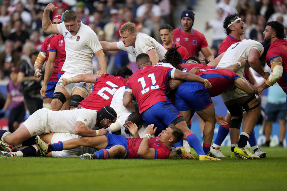 England's players react as their teammate England's Owen Farrell scores a try during the Rugby World Cup Pool D match between England and Chile at the Stade Pierre Mauroy in Villeneuve-d'Ascq, outside Lille, Saturday, Sept. 23, 2023. (AP Photo/Themba Hadebe)