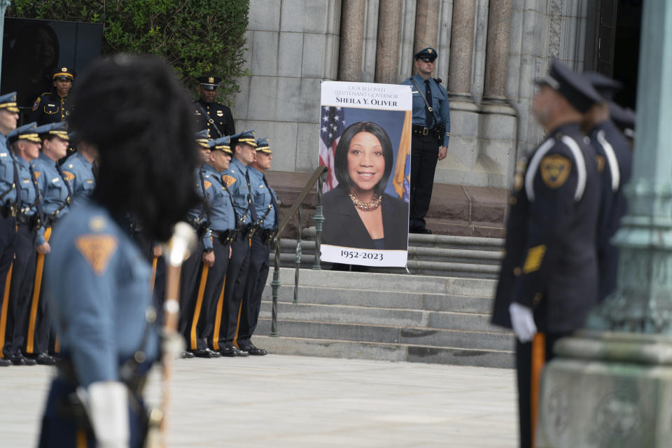 New Jersey State Police officers stand near a portrait of Lt. Gov. Sheila Oliver during her memorial service at Cathedral Basilica of the Sacred Heart in Newark on Saturday, Aug. 12, 2023. (Julian Leshay/NJ Advance Media via AP)