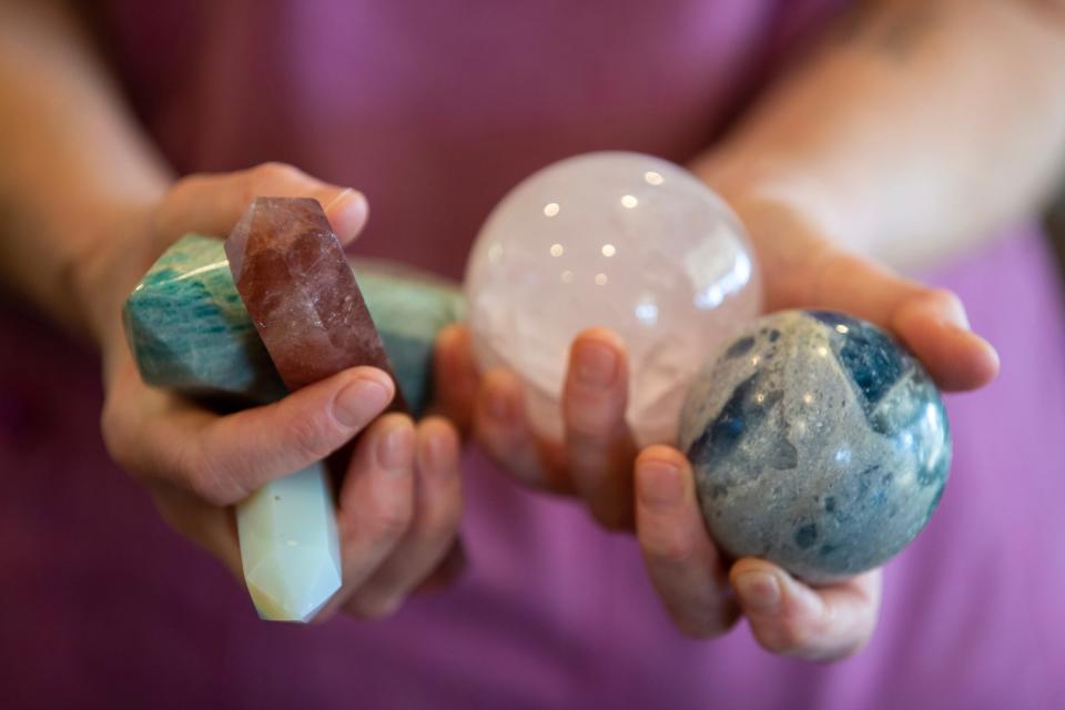 Heather Lawrence, owner of The Detox Box, a natural health studio which provides bodywork, light and sound therapy sessions, holds the crystals she uses during her therapy sessions inside the Holistic Healing Center in Colts Neck, NJ Tuesday, January 24, 2023. 