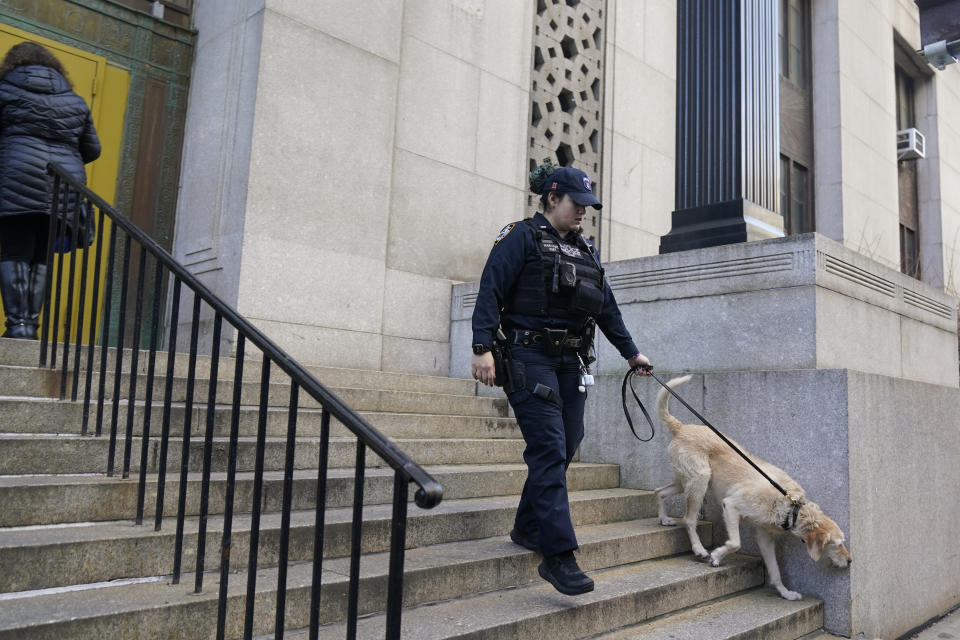 A canine unit provides security at the state office building where a grand jury investigating former President Donald Trump meets in New York, Monday, March 27, 2023. (AP Photo/Seth Wenig)