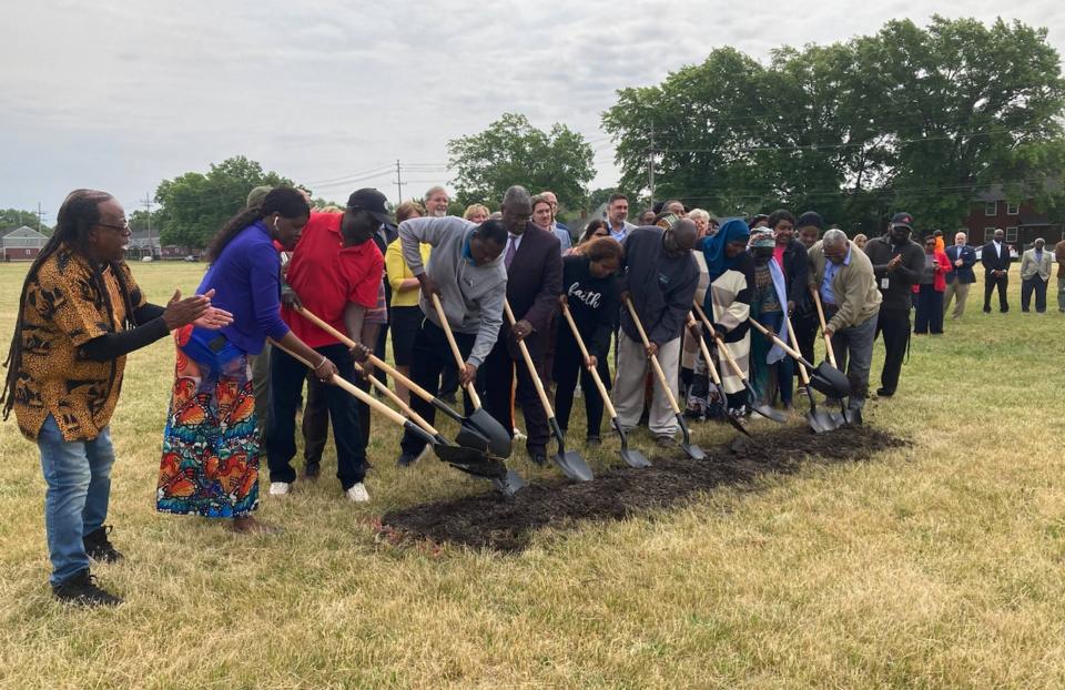 Minority Community Investment Coalition Co-Founder Gary Horton, far left, cheers on residents during a groundbreaking ceremony for a new urban agriculture project at the Joyce A. Savocchio Opportunity Park on June 15, 2023. 