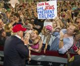 Republican presidential candidate Donald Trump greets supporters after his rally at Ladd-Peebles Stadium in Mobile, Alabama, on August 21, 2015